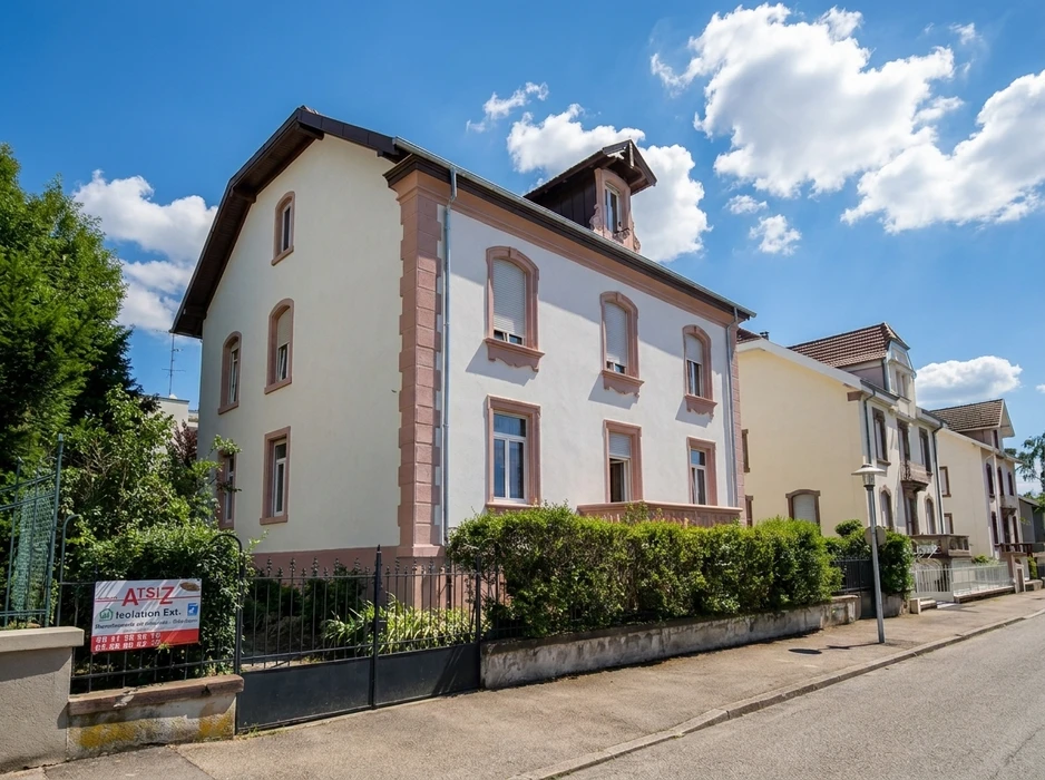 Maison bourgeoise alsacienne rénovée, façade enduite blanc-gris avec encadrements en grès rose, toiture à deux pans en ardoise synthétique